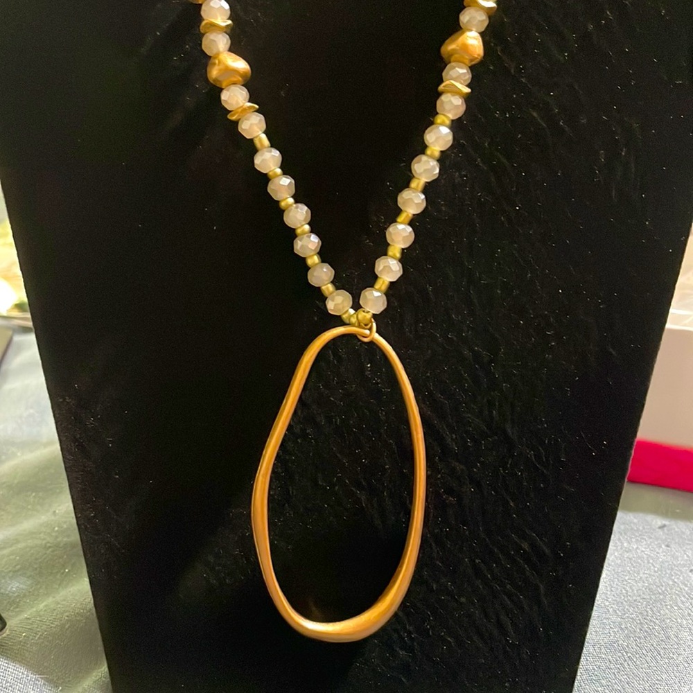 Gold long necklace with oval pendant